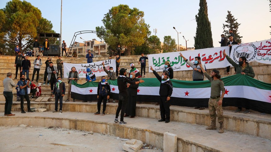 November 13, 2020, Idlib, Syria: Activists with banners and flags making gestures during the demonstration..Syrian activists in the city of Idlib organize a protest to express their rejection of the r ...