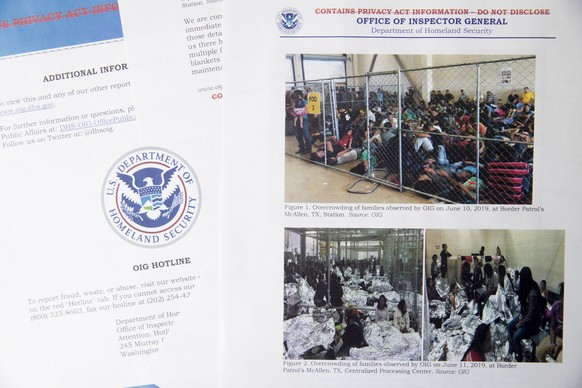 A portion of a report from government auditors reveals images of people penned into overcrowded Border Patrol facilities, photographed Tuesday, July 2, 2019, in Washington. The report released Tuesday ...