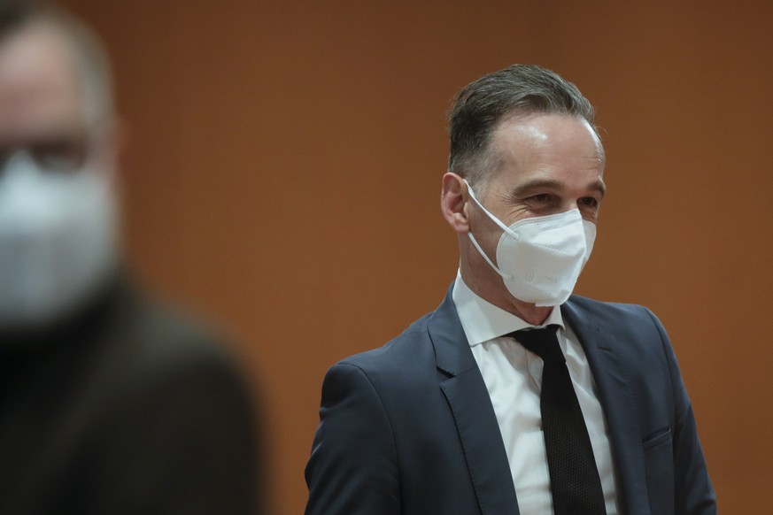 German Foreign Minister Heiko Maas, right, arrives for the weekly cabinet meeting at the chancellery in Berlin, Germany, Wednesday, March 10, 2021. (AP Photo/Markus Schreiber, Pool)