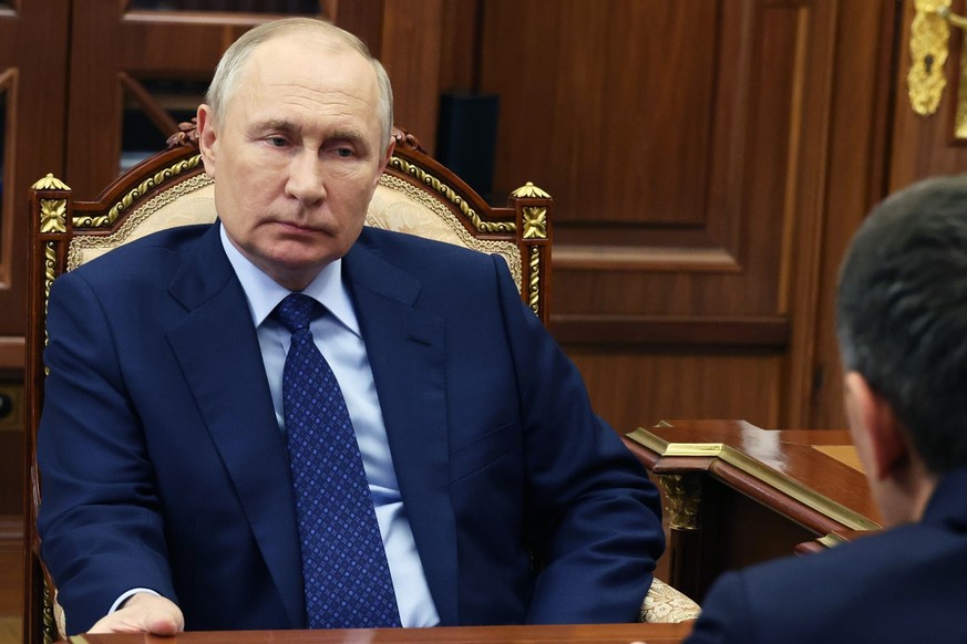 Russian President Vladimir Putin, left, listens to General Director, Chairman of the Board of PJSC Rosseti Andrey Ryumin during their meeting in Moscow, Russia, Monday, Nov. 13, 2023. (Gavriil Grigoro ...