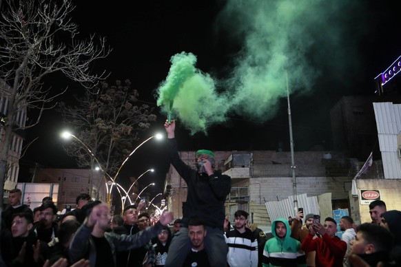 Palestinians chant as they celebrate in the center of Hebron city in the West Bank Palestinians chant as they celebrate in the center of Hebron city in the West Bank, on January 27, 2023, following th ...