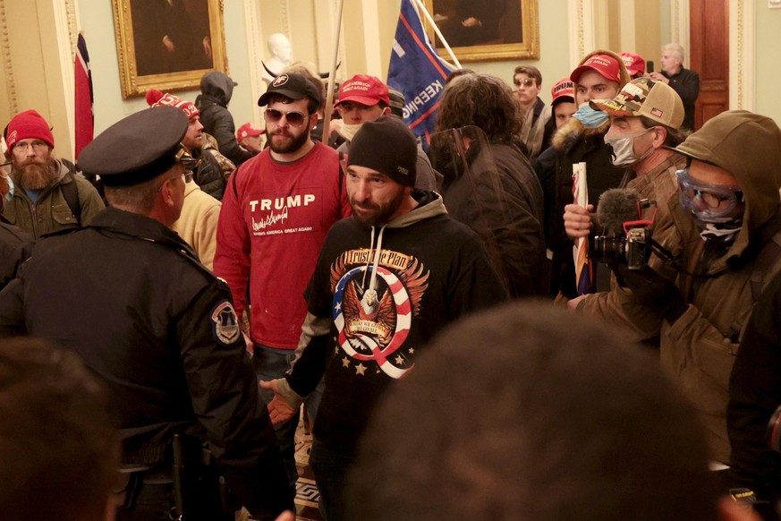 WASHINGTON, DC - JANUARY 06: Protesters interact with Capitol Police inside the U.S. Capitol Building on January 06, 2021 in Washington, DC. Congress held a joint session today to ratify President-ele ...