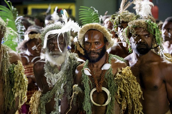 Macron on visit in Vanuatu Men in traditional attire wait for the arrival of French President Emmanuel Macron on the first day of his official visit in Vanuatu, at the international airport in Port Vi ...