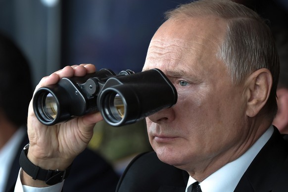 Russian President Vladimir Putin holds binoculars while watching military exercises Center-2019 at Donguz shooting range near Orenburg, Russia, on Sept. 20, 2019. Putin, whose forces invaded Ukraine o ...
