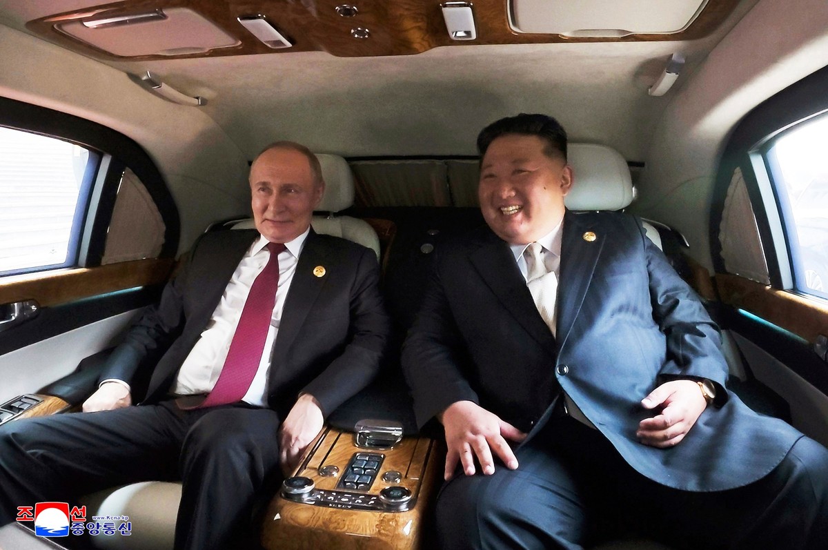 In this photo provided by the North Korean government, North Korean leader Kim Jong Un, right, and Russian President Vladimir Putin talk inside a vehicle as they move in Beijing Wednesday, Sept. 3, 20 ...
