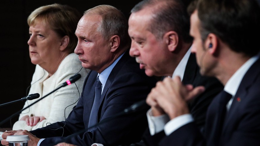 ISTANBUL, TURKEY - OCTOBER 27, 2018: Germany s Chancellor Angela Merkel, Russia s President Vladimir Putin, Turkey s President Recep Tayyip Erdogan, and France s President Emmanuel Macron (L-R) give a ...