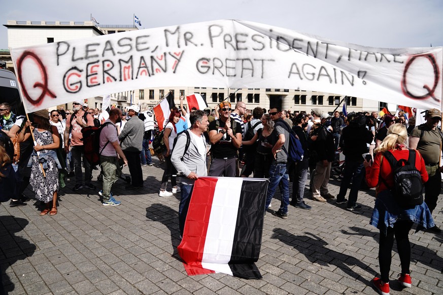 People attend a protest rally in Berlin, Germany, Saturday, Aug. 29, 2020 against new coronavirus restrictions in Germany. Police in Berlin have requested thousands of reinforcements from other parts  ...