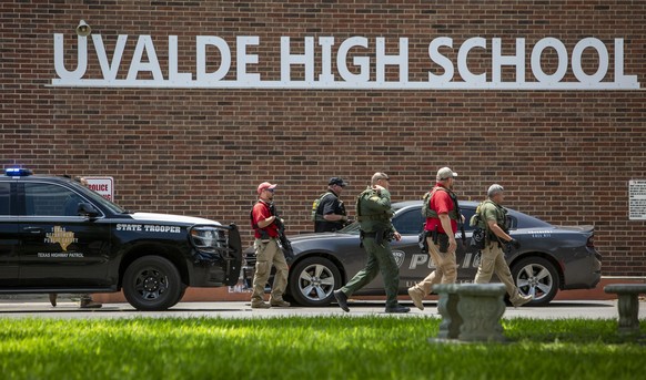 May 24, 2022, Uvalde, Texas, USA: Law enforcement officials work Tuesday, May 24, 2022 at Uvalde High School after a shooting was reported earlier in the day at nearby Robb Elementary School. Fifteen  ...