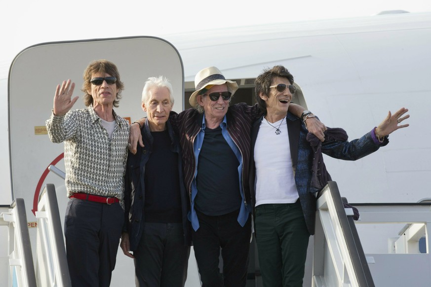 FILE - In this March 24, 2016 file photo, members of The Rolling Stones, from left, Mick Jagger, Charlie Watts, Keith Richards and Ron Wood pose for photos from their plane at Jose Marti international ...