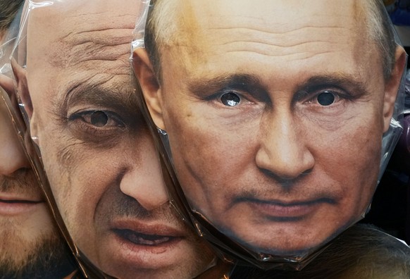 FILE - Face masks depicting Russian President Vladimir Putin, right, and owner of private military company Wagner Group Yevgeny Prigozhin are displayed among others for sale at a souvenir shop in St.  ...