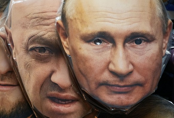FILE - Face masks depicting Russian President Vladimir Putin, right, and owner of private military company Wagner Group Yevgeny Prigozhin are displayed among others for sale at a souvenir shop in St. ...