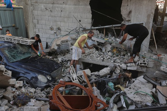 Palestinians inspect the damaged following overnight Israeli bombardment of a house at the Nuseirat refugee camp Palestinians inspect the damaged following overnight Israeli bombardment of a house at  ...