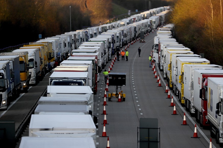 Trucks are parked up on the M20, part of Operation Stack in Ashford, Kent, England, Friday, Dec. 25, 2020. Thousands wait to resume their journey across The Channel after the borders with France reope ...