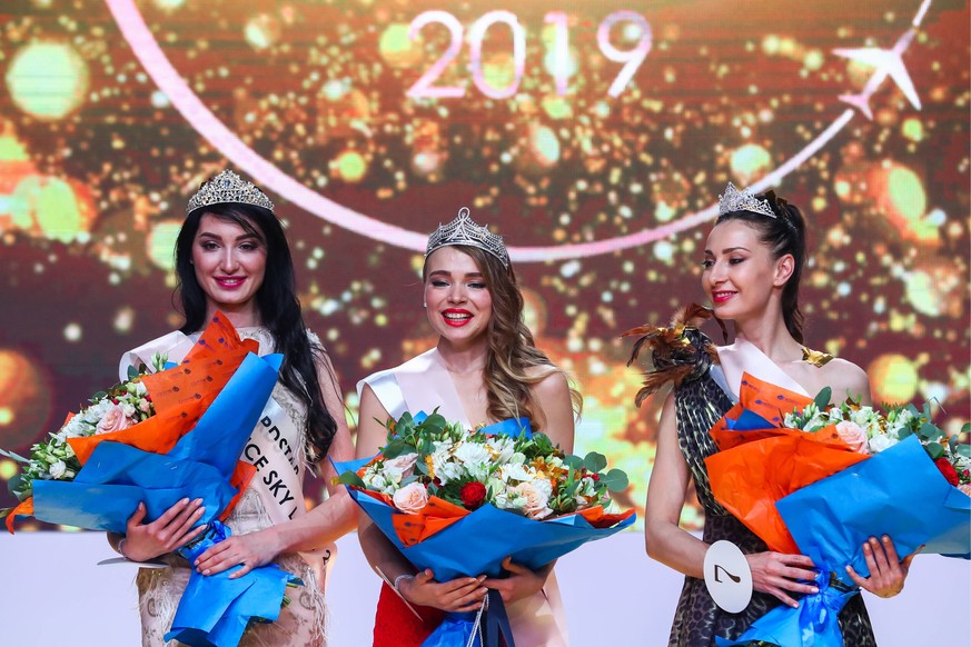 MOSCOW, RUSSIA - APRIL 25, 2019: First runner-up Zarina Stroyeva of Nordstar, winner Darya Baranova of Aeroflot, second runner-up Anzhela Beshimova of Uzbekistan Airways, from left, at a Sky Lady flig ...