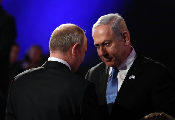 Russian President Vladimir Putin meets with Israeli Prime Minister Benjamin Netanyahu stands nearby at the World Holocaust Forum marking 75 years since the liberation of the Nazi extermination camp Au ...