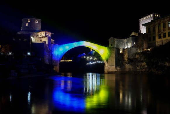 Mostar Bridge in colors of Ukraine flag Old Bridge illuminated in the colors of the Ukrainian flag as a sign of support for Ukrainians, in Mostar, Bosnia and Herzegovina, on February 25, 2022. DenisxK ...