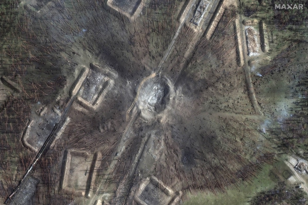 A large crater and downed trees and destroyed railcars after explosion at the Toropets ammunition depot, Russia, Sunday, Sept. 22, 2024. (Satellite image ©2024 Maxar Technologies via AP)