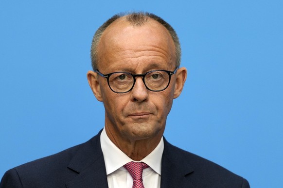 German opposition leader and Christian Democratic Union party chairman Friedrich Merz watches the media at a joint news conference with Markus Soeder, Christian Social Union party leader and state gov ...