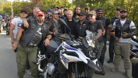 August 10, 2019, Sevastopol, Crimea, Russia: Russian President Vladimir Putin, center, poses with members of the Night Wolves biker club at the Babylon Shadow bike show and camp August 10, 2019 near S ...