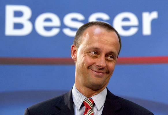 FILE PHOTO: Friedrich Merz of the conservative Christian Demococratic Union (CDU) smiles under letters reading &quot;better&quot; during a news conference in Berlin November 3, 2003 to present his tax ...
