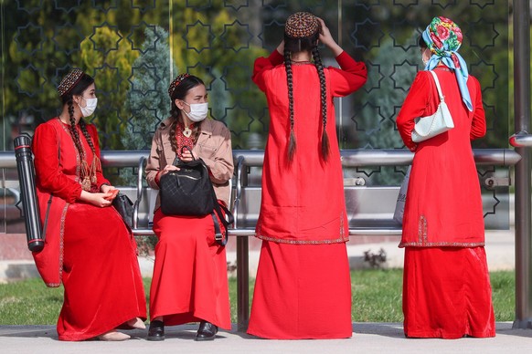 ASHGABAT, TURKMENISTAN - MARCH 10, 2022: Women are seen at a public transport stop in the city of Ashgabat. Vladimir Smirnov/TASS PUBLICATIONxINxGERxAUTxONLY TS1273EB