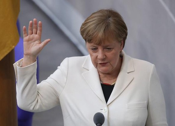 BERLIN, GERMANY - MARCH 14: German Chancellor Angela Merkel takes her oath to serve her fourth term as chancellor following her election by the Bundestag on March 14, 2018 in Berlin, Germany. Members  ...