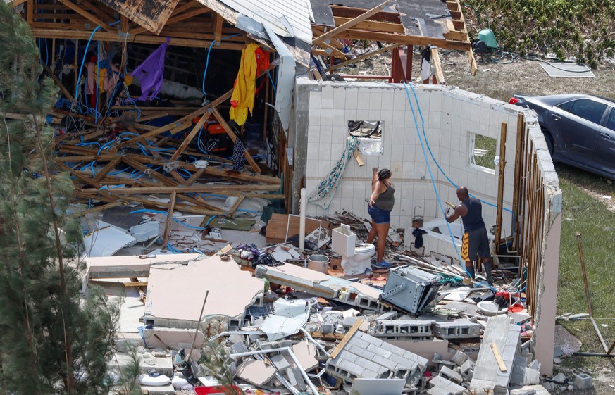 Residents look through debris after hurricane Dorian hit the Grand Bahama Island in the Bahamas, September 4, 2019. REUTERS/Joe Skipper