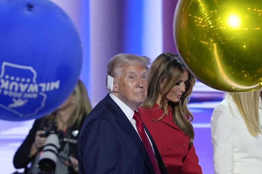 From l-r., Republican presidential candidate former President Donald Trump, walking on stage with former first lady Melania Trump at the end of the Republican National Convention, Thursday, July 18, 2 ...