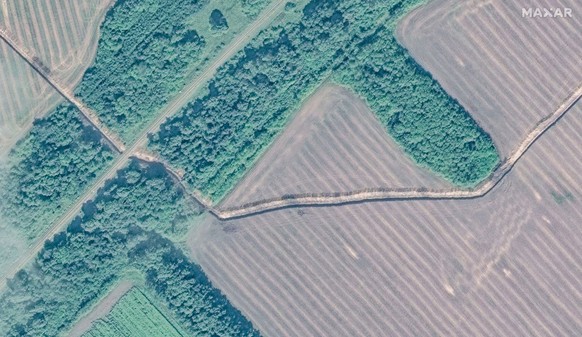 Satellite image shows a new series of defensive trenches that have been built near Lgov extending east from the village of Selektsionnyi toward the outskirts of nearby Lgov, Russia August 12, 2024. Ma ...