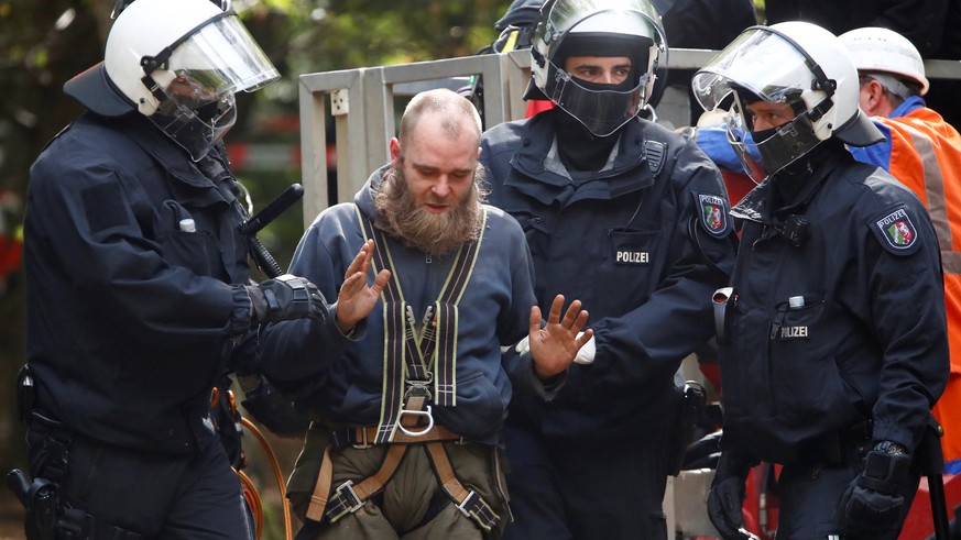 An activist is detained after being removed from the treehouse, as police attempt to clear the area at the &quot;Hambacher Forst&quot; in Kerpen-Buir near Cologne, Germany, September 16, 2018. REUTERS ...