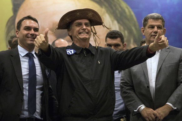 FILE - In this Oct. 11, 2018 file photo, presidential candidate Jair Bolsonaro flashes two thumbs up during a press conference in Rio de Janeiro, Brazil. The success of Bolsonaro's campaign caught man ...