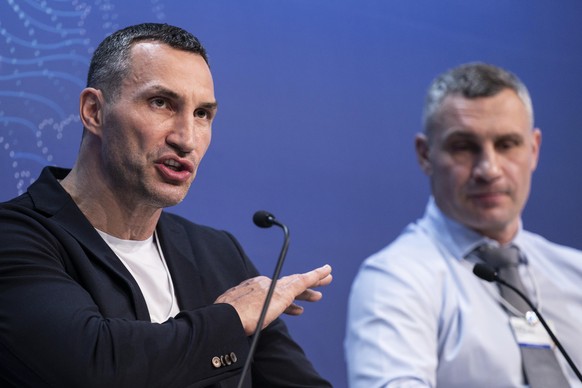 Wladimir Klitschko, Ukrainian former professional boxer and businessman, left, and his brother Vitali Klitschko, Mayor of Kyiv and also former professional boxer, addresses a panel session during the  ...