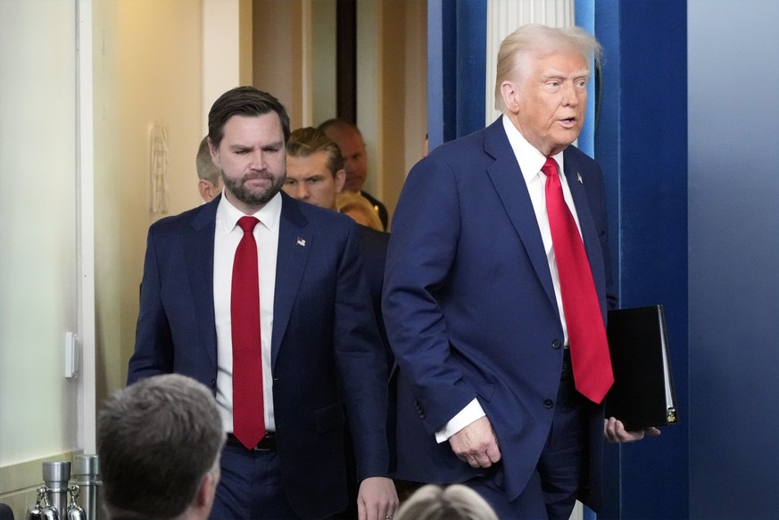 President Donald Trump, followed by Vice President JD Vance, arrives to speak in the James Brady Press Briefing Room at the White House, Thursday, Jan. 30, 2025, in Washington. (AP Photo/Alex Brandon)