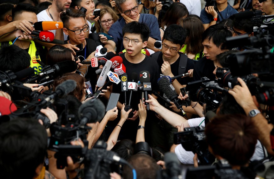 FILE PHOTO: Pro-democracy activist Joshua Wong talks to the media outside the Legislative Council during a demonstration demanding Hong Kong's leaders to step down and withdraw the extradition bill, i ...