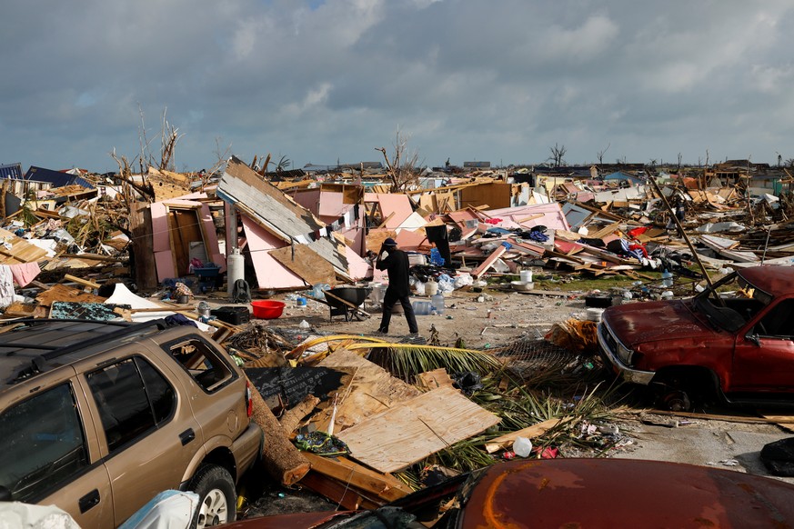 A man walks among debris at The Mud neighborhood, devastated after Hurricane Dorian hit the Abaco Islands in Marsh Harbour, Bahamas, September 6, 2019. REUTERS/Marco Bello