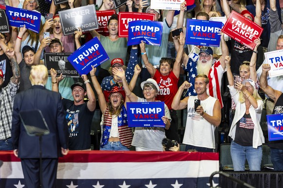 Fans cheer on former president Donald Trump during his campaign rally in downtown Grand Rapids, Mich. on Saturday, July 20, 2024. (Kaytie Boomer/Saginaw News via AP)