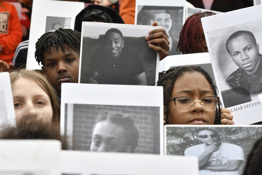 FILE - Students from Philadelphia hold photos of gun violence victims at a rally at the Pennsylvania Capitol pressing for stronger gun-control laws, March 23, 2023, in Harrisburg, Pa. Authorities coul ...