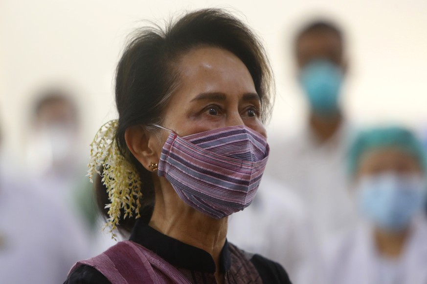 FILE - In this Jan 27, 2021, file photo, Myanmar leader Aung San Suu Kyi watches the vaccination of health workers at hospital in Naypyitaw, Myanmar. Reports says Monday, Feb. 1, 2021 a military coup  ...
