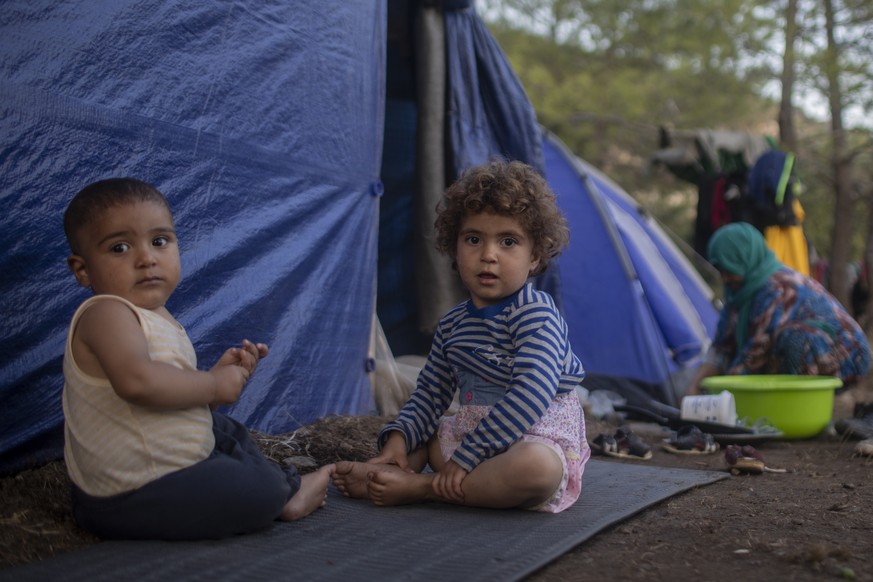 Syrians children play outside a makeshift tent near the refugee and migrant camp at the Greek island of Samos on Wednesday, Sept. 25, 2019. The refugee and migrant camp of Samos island hosts more than ...