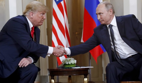 FILE - President Donald Trump, left, and Russian President Vladimir Putin shake hands at the beginning of a meeting at the Presidential Palace in Helsinki, Finland, July 16, 2018. (AP Photo/Pablo Mart ...