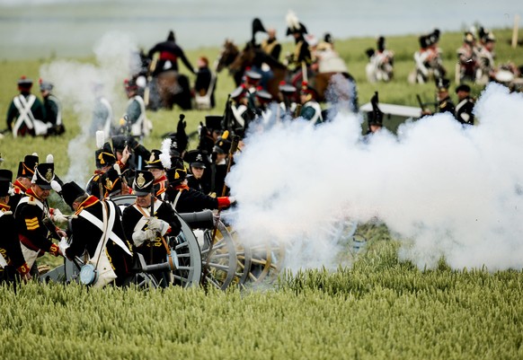 epa04809273 Reenactors perform on the battle field during the first reenactment of 'The French Attack' during the bicentennial celebrations for the Battle of Waterloo, in Braine l'Alleud, Belgium, 19  ...