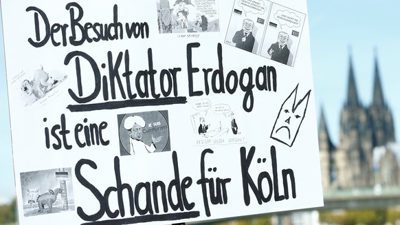 Plackard that reads &quot;The visit of dictator Erdogan is a shame for Cologne&quot; is seen before the official inauguration of the Cologne Central Mosque in the Cologne&#039;s suburb of Ehrenfeld, G ...