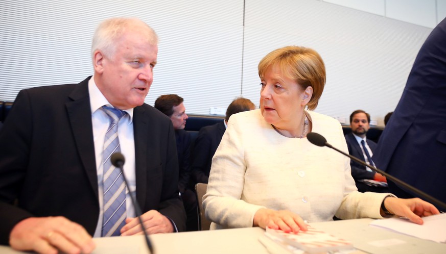 German Chancellor Angela Merkel and Interior Minister Horst Seehofer arrive for a CDU/CSU fraction meeting in Berlin, Germany, July 3, 2018. REUTERS/Hannibal Hanschke