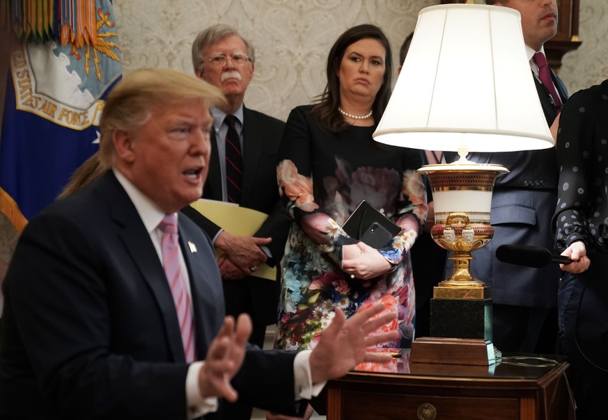 WASHINGTON, DC - APRIL 09: National Security Adviser John Bolton and White House Press Secretary Sarah Sanders listen to U.S. President Donald Trump speak during a meeting with Egyptian President Abde ...