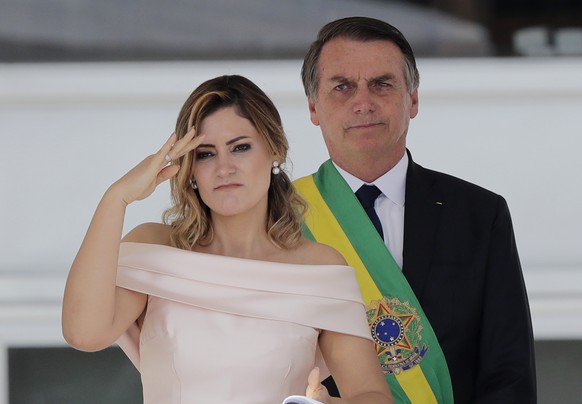 CORRECTS TO SAY SHE IS SPEAKING SIGN LANGUAGE, NOT SALUTING - Brazil&#039;s new first lady Michelle Bolsonaro uses sign language to speak to the public, as her husband, President Jair Bolsonaro, stand ...