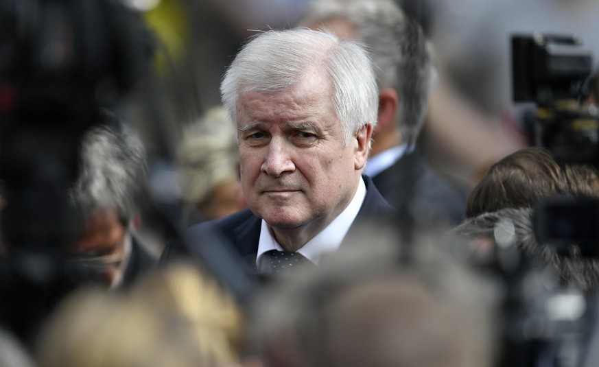 German interior minister Horst Seehofer visits the place in Muenster, Germany, Sunday, April 8, 2018 where a vehicle crashed into a crowd yesterday. A van crashed into people drinking outside a popula ...