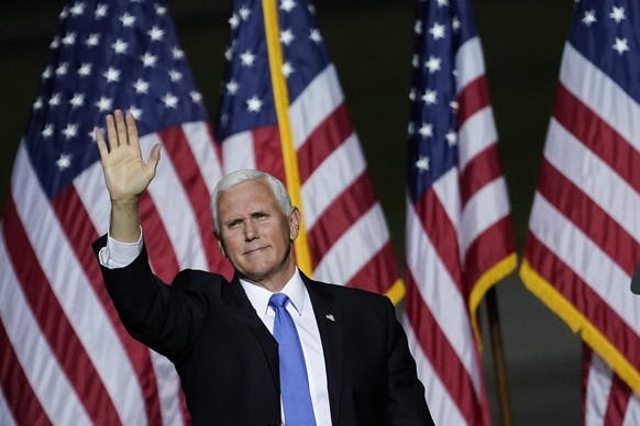 NEWPORT NEWS, VA - SEPTEMBER 25: Vice President Mike Pence waves after speaking during a campaign rally at Newport News/Williamsburg International Airport on September 25, 2020 in Newport News, Virgin ...