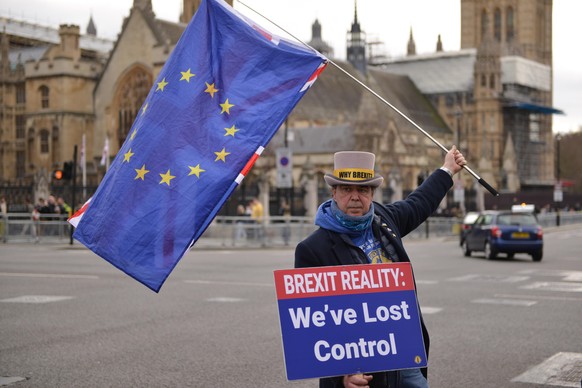 February 9, 2022, London, United Kingdom: Anti Brexit protester, STEVEN BRAY waving the EU flag with a placard outside the Houses of Parliament, during the demonstration. Anti Tory and Anti-government ...