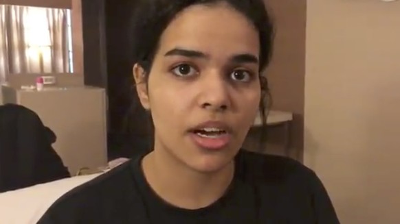 In this Monday, Jan. 7, 2019, image made from video released by Rahaf Mohammed Alqunun/Human Rights Watch, Rahaf Mohammed Alqunan views her mobile phone as she sits barricaded in a hotel room at an in ...
