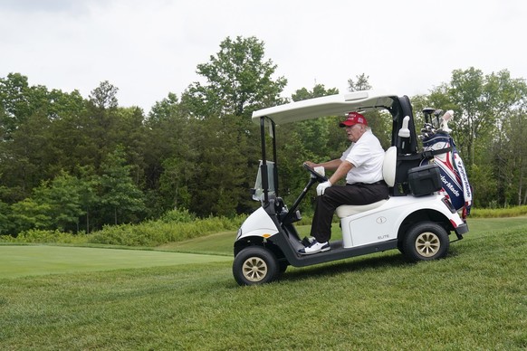 Former President Donald Trump rides in a golf cart while playing during the pro-am round of the Bedminster Invitational LIV Golf tournament in Bedminster, NJ., Thursday, July 28, 2022. (AP Photo/Seth  ...